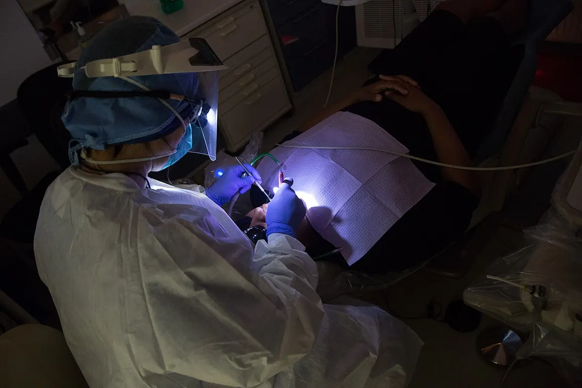 Dentist treating a patient in a modern dental chair
